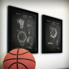 two framed basketballs are hanging on the wall