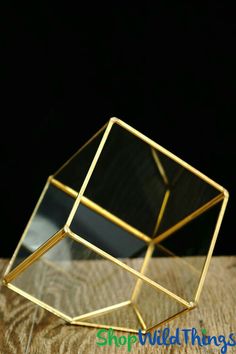 a glass box sitting on top of a wooden table