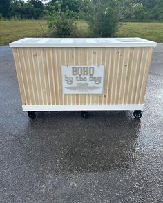 a cooler sitting in the middle of a parking lot with words on it that read boho by the bay