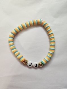 the beaded bracelet has two letters on it