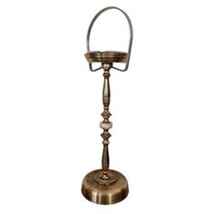 an old fashioned brass candle holder on a white background