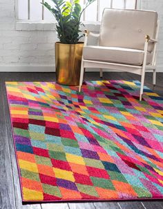 a colorful area rug with a chair and potted plant