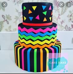 a multi - layer cake decorated with bright colors