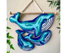 two blue and white dolphins hanging on a wall