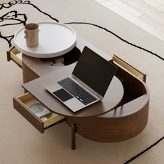 an open laptop computer sitting on top of a wooden table next to a white rug