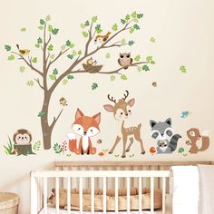 a baby's room with an animal wall decal and crib bedding