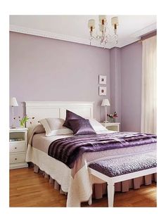 a bedroom with purple walls and white furniture