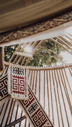 the inside of a yurt that is decorated with red and white designs