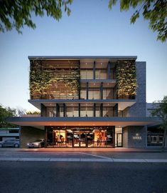 an architecturally designed building with plants growing on it's side and windows above the entrance