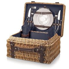 a wicker picnic basket with utensils, plates and napkins in it