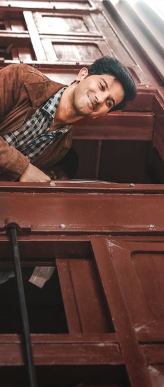 a man leaning on the side of a train car