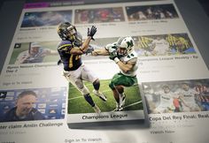 two football players are running for the ball in front of an advertiser's photo