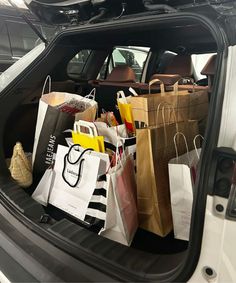 the back end of a car filled with shopping bags