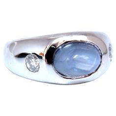 Raised halo sugarloaf. 6ct Natural Cabochon cut sapphire ring. Gray Blue color / Transluscent 9x6mm .40ct Natural Side round diamonds. G-color Si-1 clarity. 14kt. white gold 12.6 grams Ring Current size: 7.5 depth of ring: 9mm (Free Resize Service, Please inquire) $5000 Appraisal Certificate to accompany. Luxury Silver Diamond Ring With Cabochon, Jewlery Aesthetic, Jewelry Studio Space, Y2k Tech, Jewelry Nails, Marble Rings, Blue Sapphire Ring, Dope Jewelry, Cabochon Ring