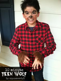 a young boy wearing a red and black plaid shirt with his hands on his hips