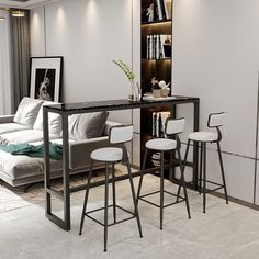 a living room with white furniture and bookshelves