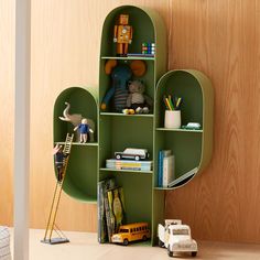 a green shelf filled with toys and books