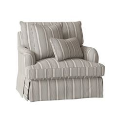 a striped chair with two pillows on it's back and the seat upholstered