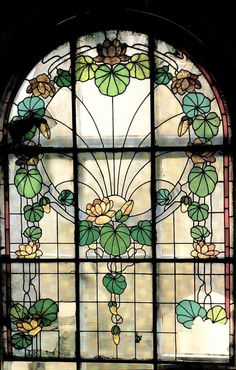 a stained glass window with flowers and leaves