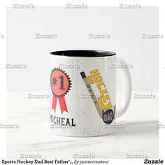 a white and black coffee mug with hockey stickers on it