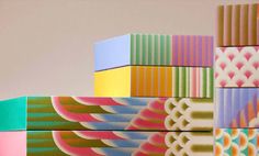 colorful boxes stacked on top of each other with different patterns and colors painted on them