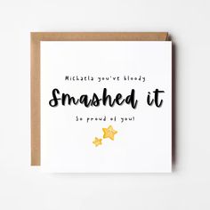 a card with the words smashed it written in black ink and gold stars on top