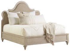 a bed with white linens and pillows on it's headboard, in front of a white background