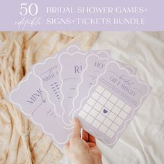 the bridal shower games are being held by someone's hand on a bed