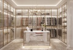 an elegant walk in closet with glass walls and chandelier