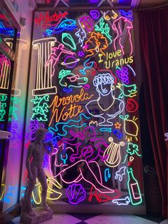 a neon sign in the corner of a room that is lit up with various colored lights