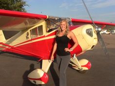 a woman standing in front of an airplane