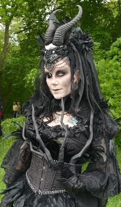 a woman dressed in black and white with horns