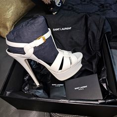 Saint Laurent Tribute T-Strap Sandal Ysl 100% Authentic Comes In Its Original Box & Dust Bags Condition: Brand New Never Worn But Comes With A Tiny Cut Next To The Heel (See Photos) Damaged In Shipping Size: 37 Made In Italy Color : White Leather Original Retail Price - $1,090.00 Sleek, Contemporary Lines Define An Elegant T-Strap Sandal Crafted With Matte Leather. Approx. Heel Height: 5 1/2" With 1 1/2" Platform (Comparable To A 4" Heel). Leather Upper, Lining, And Sole. All Sales Are Final Ele Ysl Tribute Heels, Saint Laurent Shoes, T Strap Sandals, T Strap, High Quality Leather, Strap Sandals, White Leather, Women's Shoes Sandals, Stiletto Heels