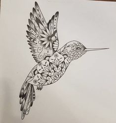 a black and white drawing of a hummingbird with flowers on it's wings