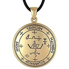 a gold pendant with an image of the zodiac sign and symbols on it, hanging from a black cord