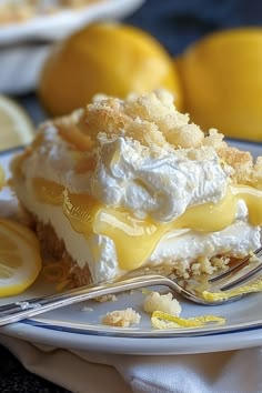 a piece of lemon meringue pie on a plate with a fork next to it