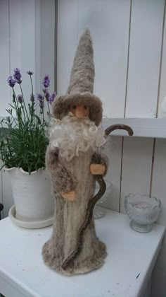 a gnome figurine sitting on top of a white shelf