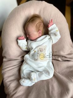 a baby laying on top of a bean bag chair