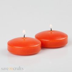 two red candles sitting next to each other