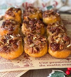 a bunch of pecans sitting on top of a piece of paper next to christmas decorations