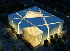 an aerial view of a building lit up at night with people walking around the building