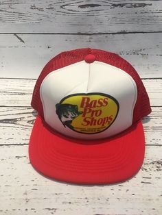 Vintage Bass Pro Shops Fish Logo Mesh Trucker Red Fishing Hat Cap Snapback This is a vintage Snapback by Bass Pro Shops and it is a true classic and it’s in great shape! Again it has no rips or tears, it’s very crispy. If there is any wear and tear then it is extremely small. Like we notice very small, minute spots barely noticeable and some small creases in the hat as well too. Plus this hat has the small rope on it as well so it’s extremely vintage! Our number one goal is complete guest satisf Bass Pro Hats, Bass Pro Shop Hat, Bass Pro Shop, Kids Camp, Vintage Bass, Vintage Snapback, Fish Logo, Fishing Hat, Rich People