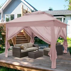 a patio with a couch and a pink canopy