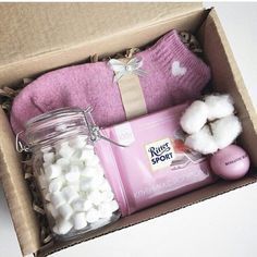 a pink box with cotton and other items in it