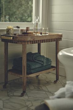 a bath room with a tub and a mirror on the wall next to a sink