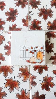 autumn leaves and pumpkins on white tiles