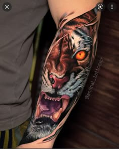 a man with a tiger tattoo on his arm and leg, showing the face of an animal