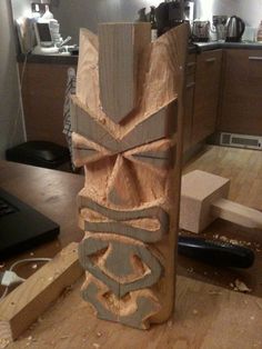 a wooden sculpture sitting on top of a hard wood floor