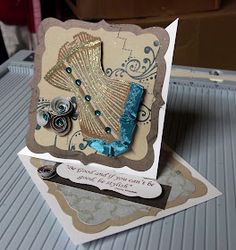 a close up of a card on a table with a box in the back ground