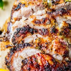 grilled pork chops on a cutting board with lemon wedges